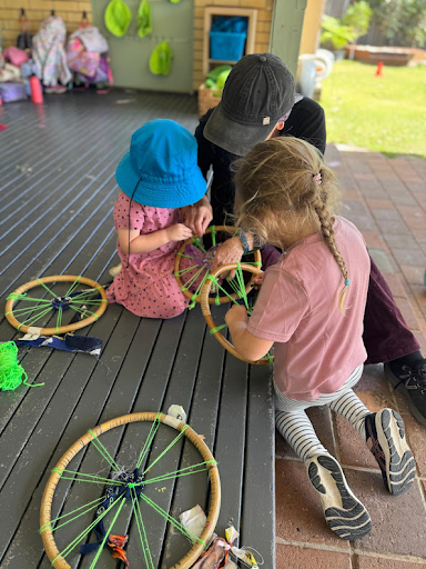 A Grand Friend and children weaving with wheels