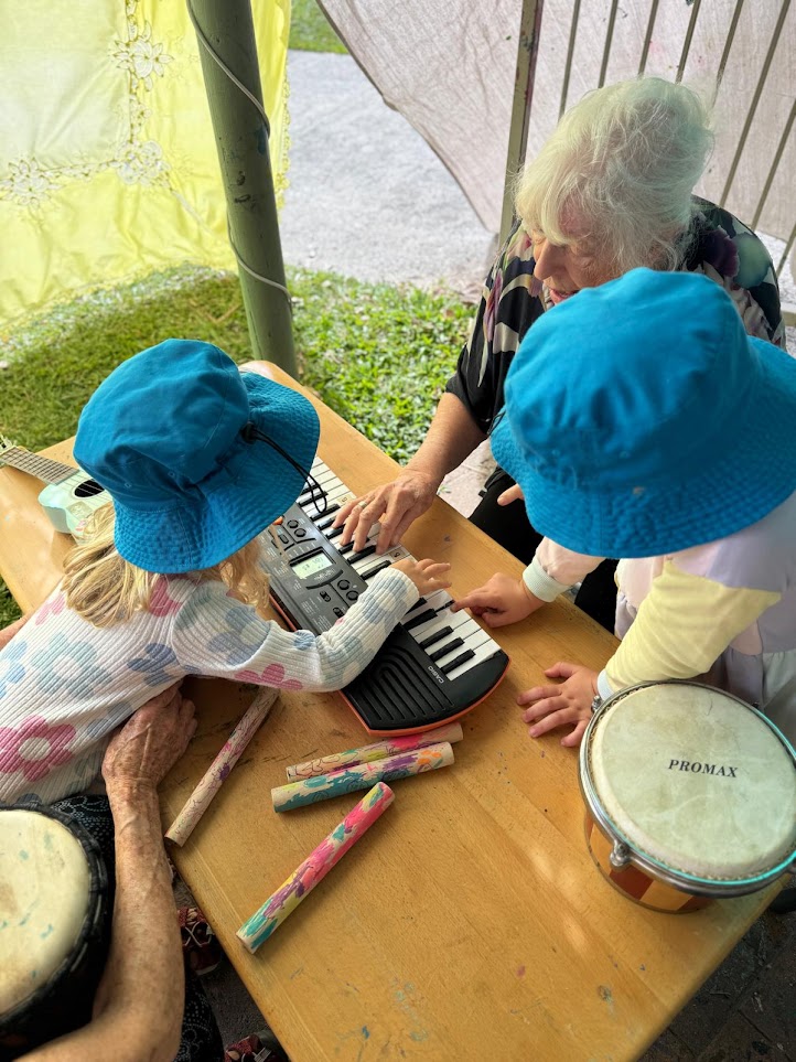 A Grand Friend playing keyboard with children
