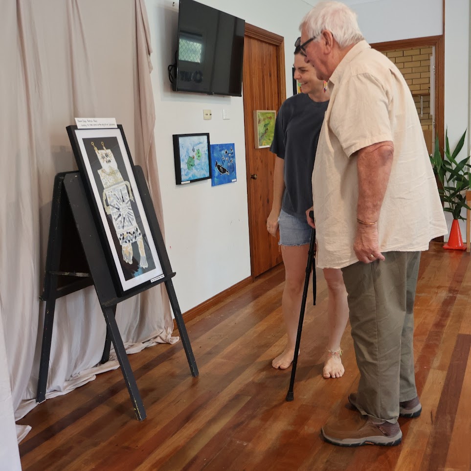 Admiring children's artwork at the exhibition