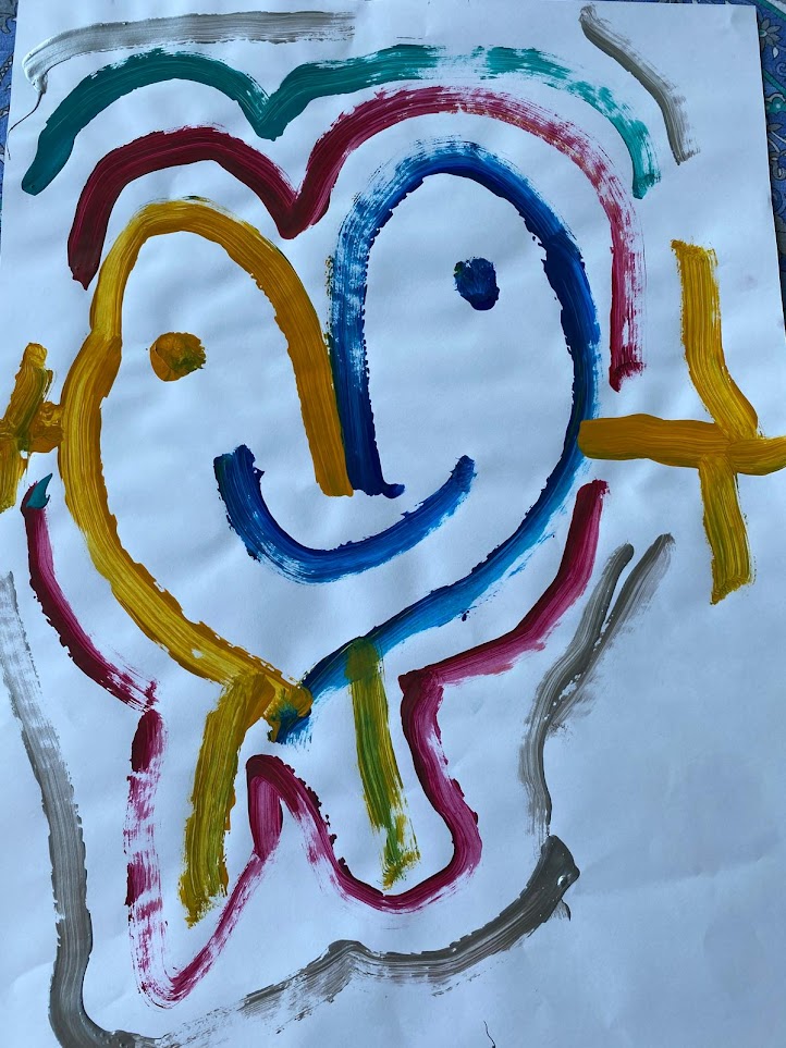 Rainbow face painting by a child