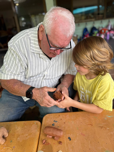 Hands shaping clay together